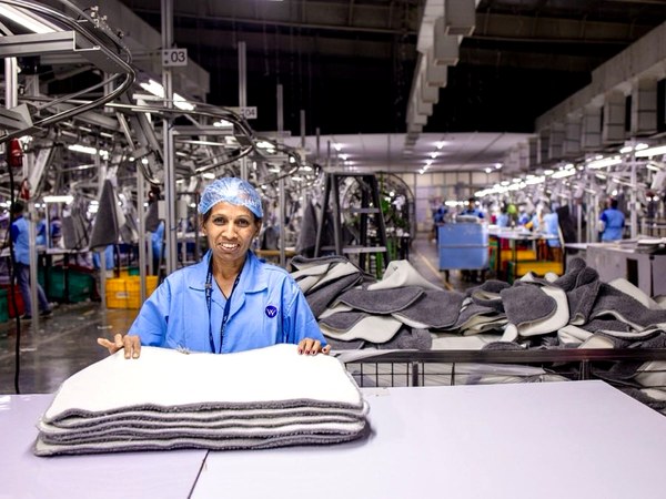 Garment factory operator at an industrial sewing station