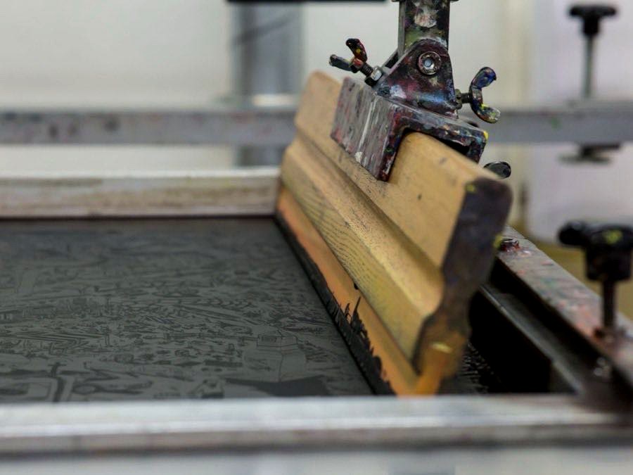 Screen printing being applied to garment panels